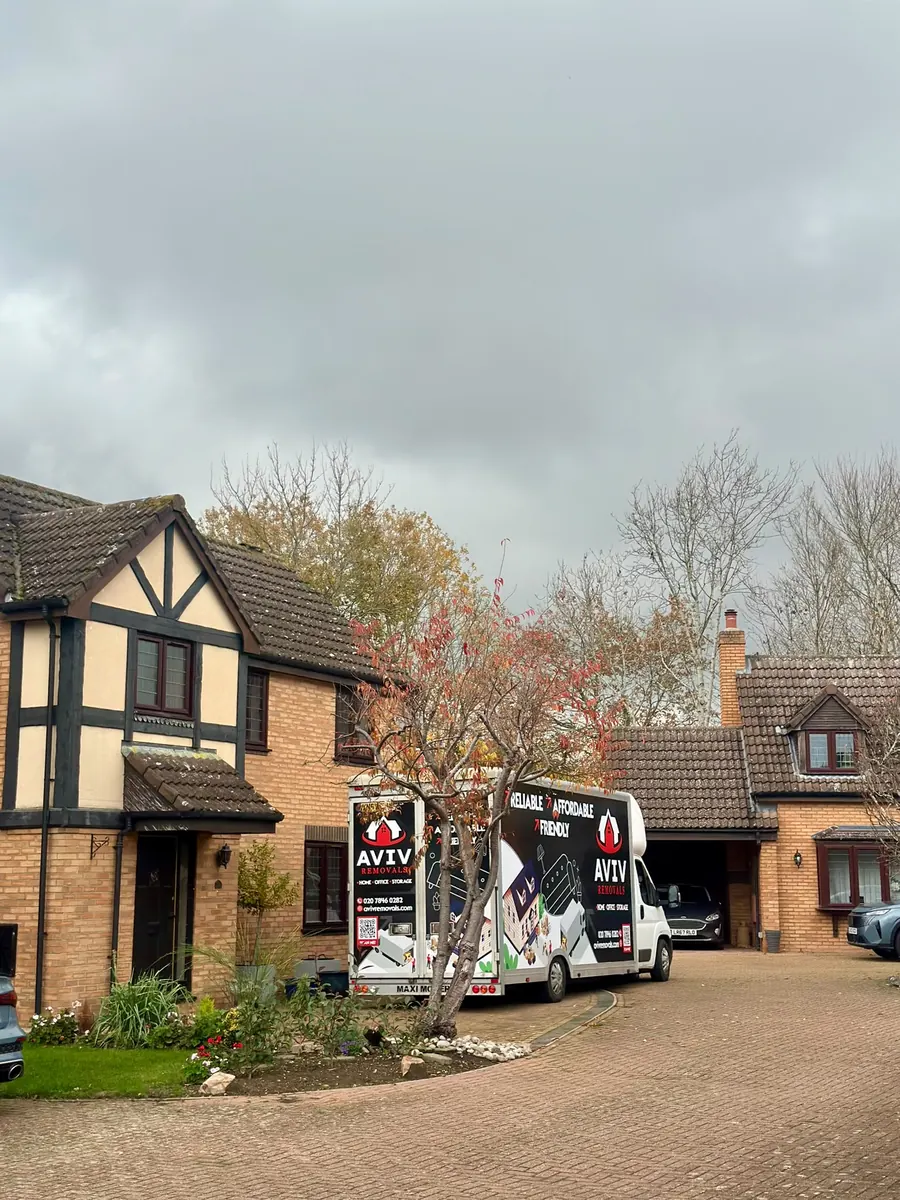 London house removal - Aviv Removals van on the driveway of a suburban family home